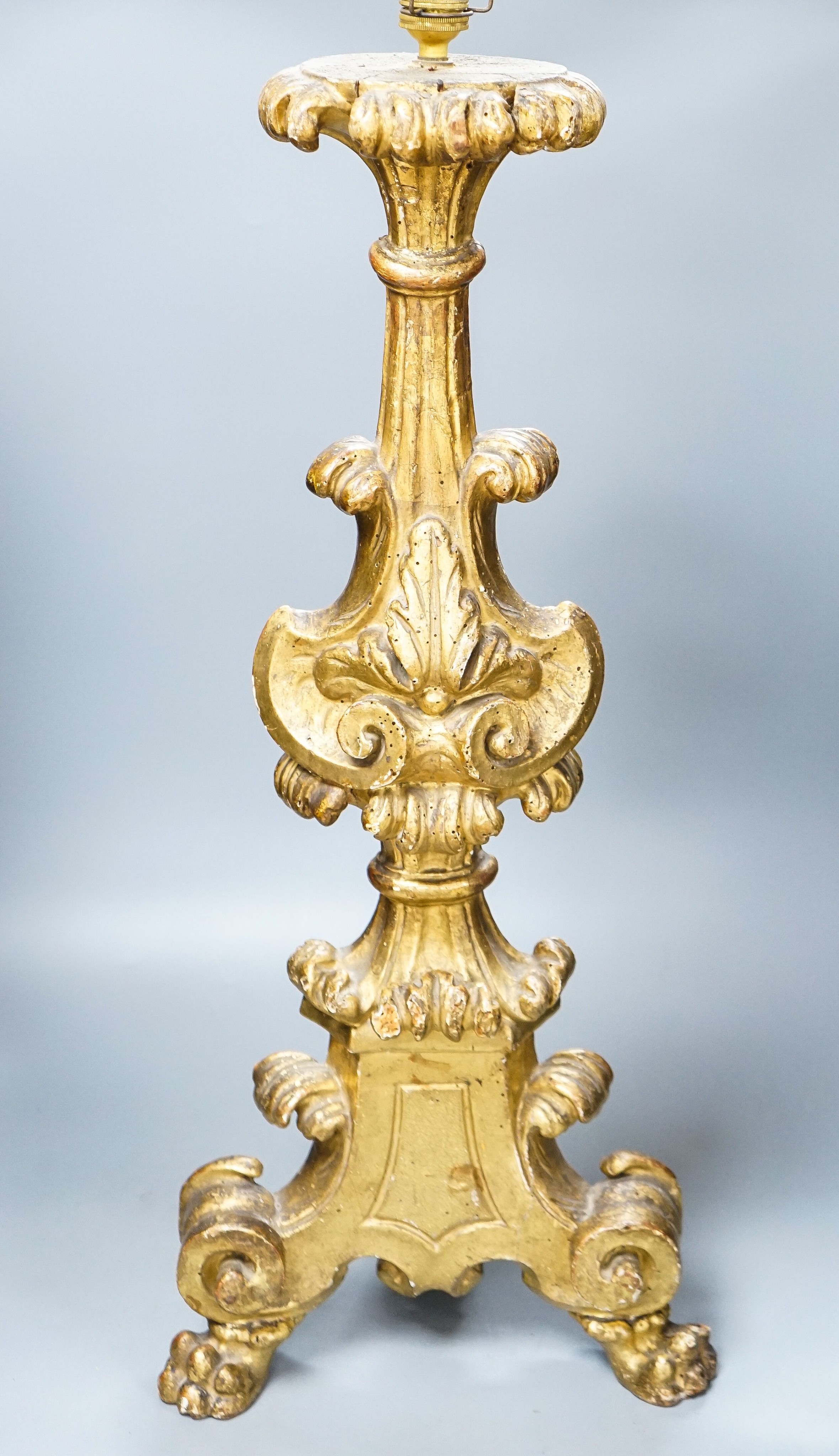 An 18th century Italian giltwood candlestand, foliate and scroll-carved